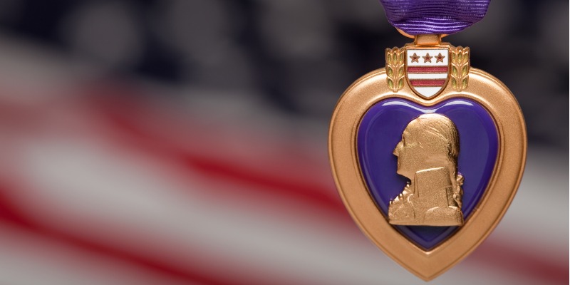 purple-heart-against-american-flag-picture-id92117540